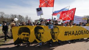 epa05938942 Members of the opposition party 'Open Russia' carry a banner reads as 'Bored' with portraits of Russian President Vladimir Putin, Prime minister Dmitry Medvedev and President of Chechen Republic Ramzan Kadyrov during a May Day rally in St. Petersburg, Russia, 01 May 2017. Labor Day or May Day is observed all over the world on the first day of the May to celebrate the economic and social achievements of workers and fight for laborers rights.  EPA/ANATOLY MALTSEV