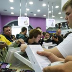 A cashier scans an iPhone 6 in a mobile phone shop in Moscow