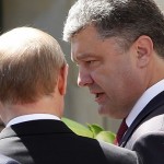 Poroshenko talks to Putin after a group photo  in Benouville