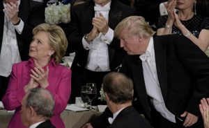 Republican presidential nominee Donald Trump moves Democratic presidential nominee Hillary Clinton's chair  during the Alfred E. Smith Memorial Foundation Dinner at Waldorf Astoria October 20, 2016 in New York, New York. / AFP PHOTO / Brendan Smialowski