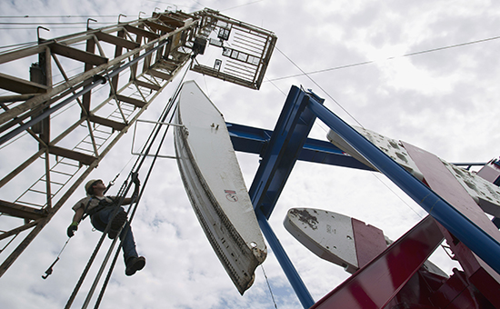 FILE - In this July 26, 2011, file photo, a worker hangs from an oil derrick outside of Williston, N.D. Justin Kringstad, the director of the North Dakota Pipeline Authority said proposed increases of tar sands oil from Canada likely will not have an impact on the state's soaring oil production. Kringstad said refinery destinations for the two crudes may differ because heavy sour crude from Alberta's tar sands is of lower-value and more difficult to refine than North Dakota's light sweet crude. (AP Photo/Gregory Bull, File)