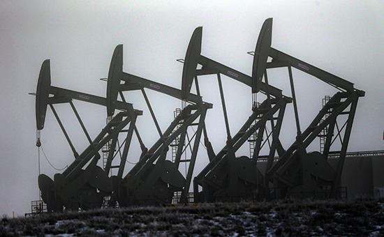 FILE - In this Dec. 19, 2014 file photo, oil pump jacks work in unison, in Williston, N.D.  In the year since the energy industry last gathered in for its big annual confab in Houston, prices for oil and natural gas took a dive that few, if anyone, saw coming. In 2015, natural gas has fallen even further than oil as U.S. drillers have been producing enormous amounts of gas and mild winter weather kept demand relatively low.  (AP Photo/Eric Gay, File)