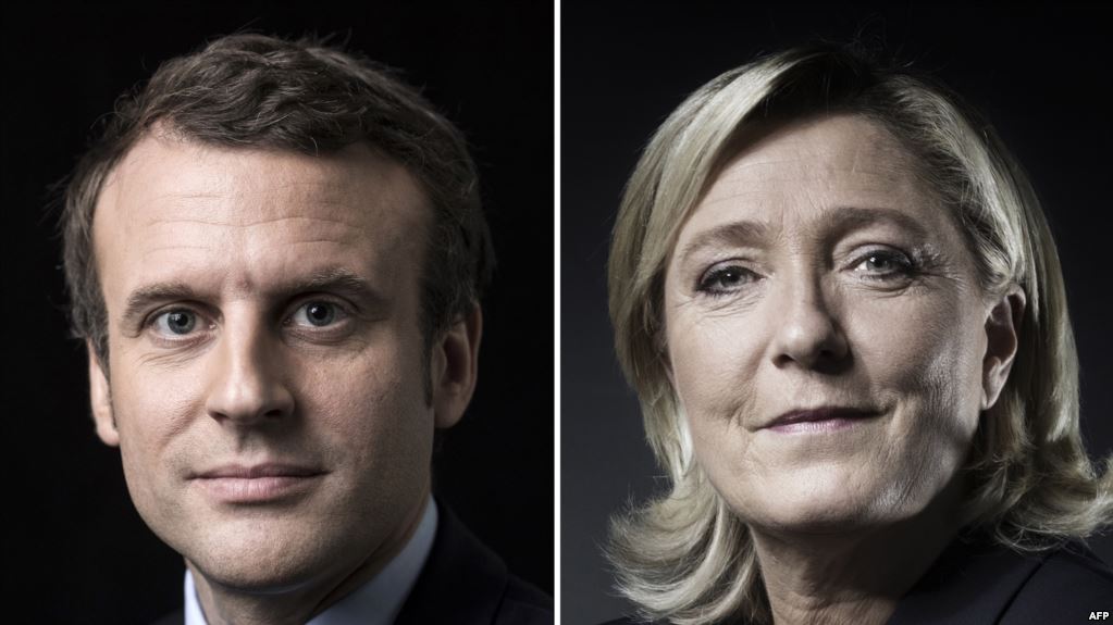 A combination of picture made on April 23, 2017 shows French presidential election candidate for the En Marche ! movement Emmanuel Macron and French presidential election candidate for the far-right Front National (FN) party Marine Le Pen posing in Paris. Emmanuel Macron and Marine Le Pen are shown ahead in the French presidential race, in a projection announced on April 23, 2017.  / AFP PHOTO / Joël SAGET AND Eric Feferberg