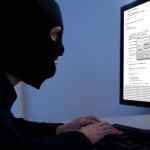 Hacker downloading information off a computer