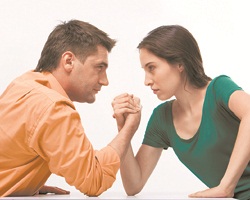 Man and woman doing arm wrestling showing their displeasure