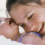 Mother Resting Head on Infant's Chest